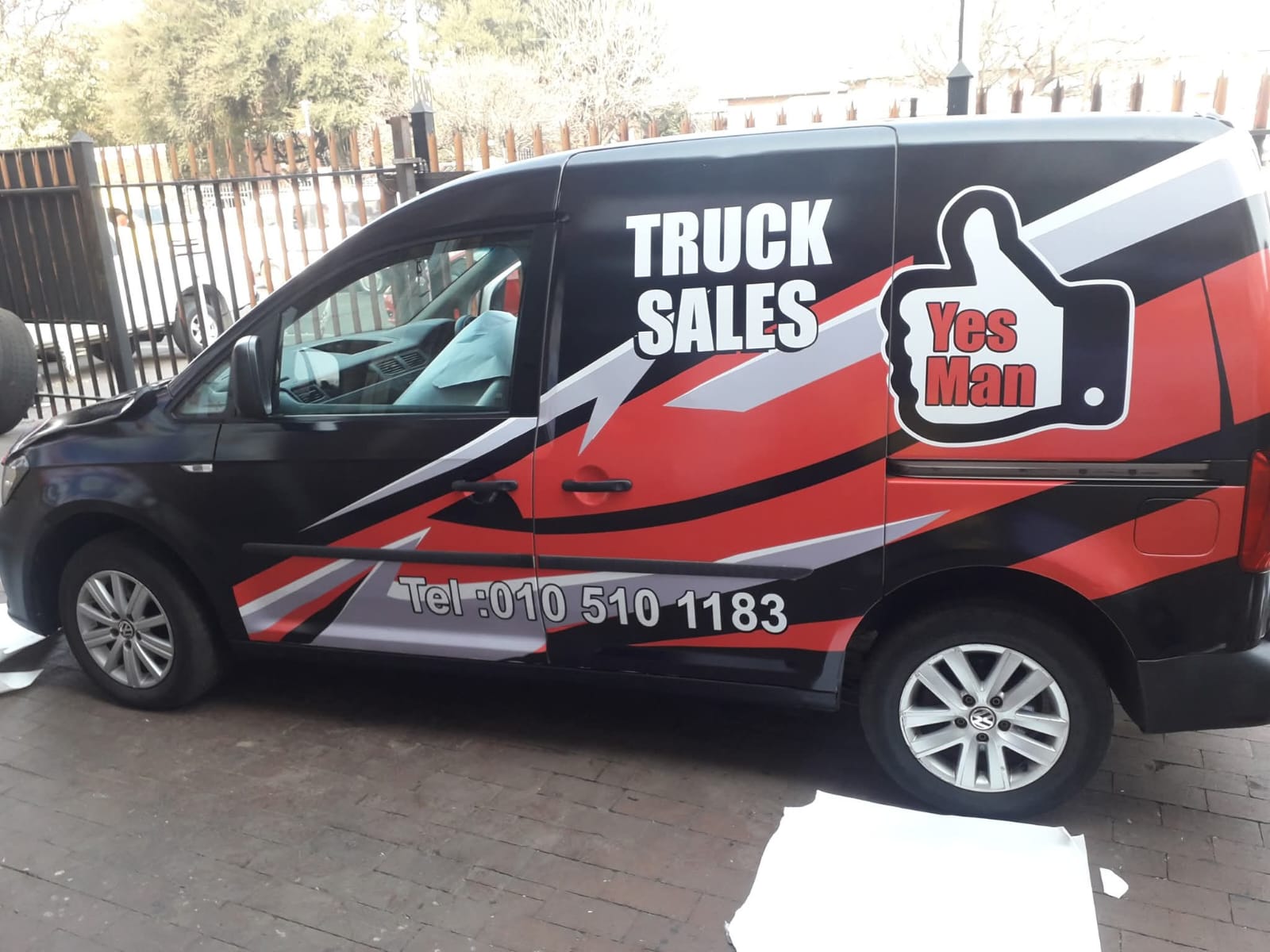 Professional Truck Sales Vehicle Wrap - Red Black and White Branding